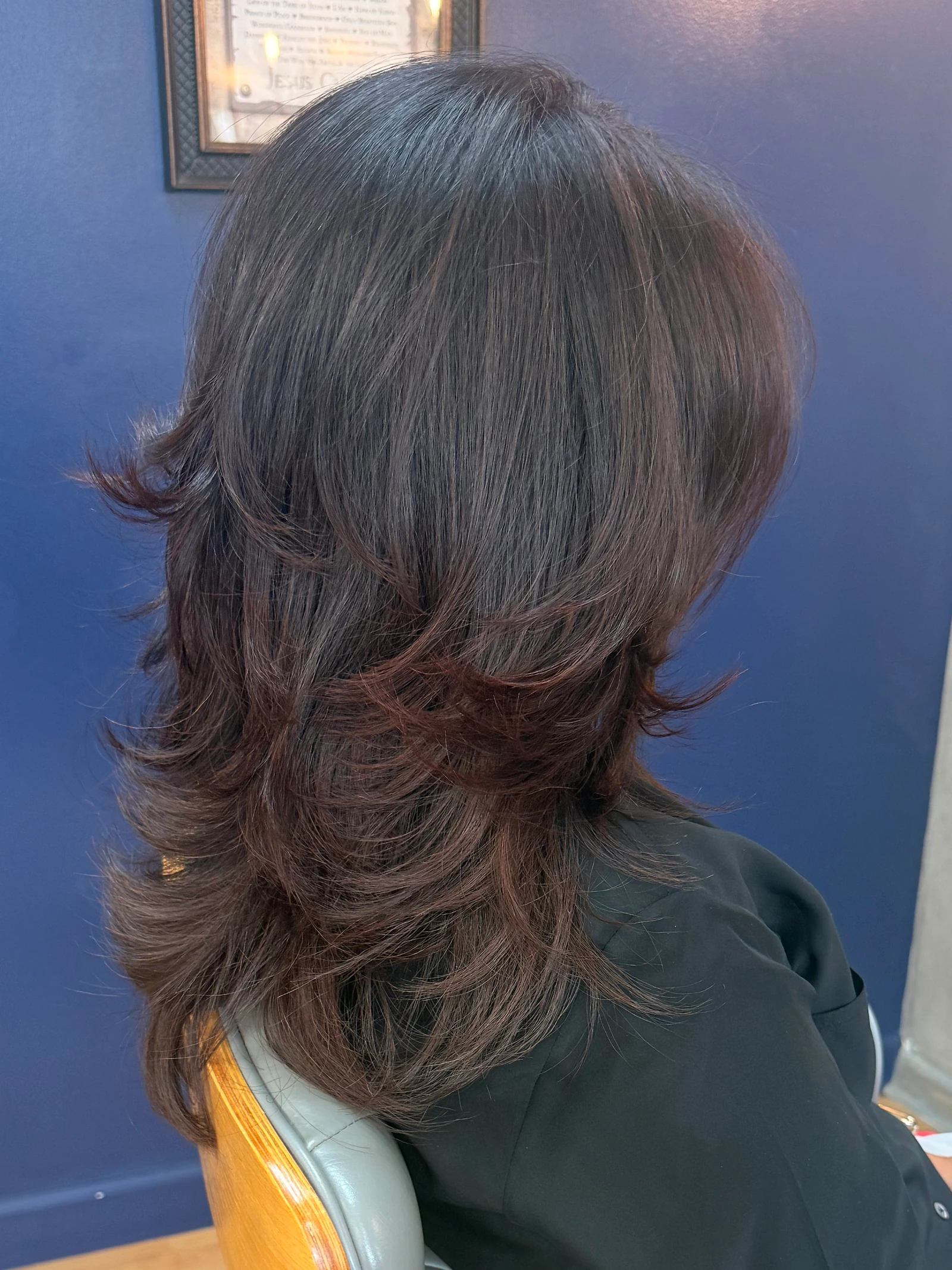 Dark hair after color and a layered haircut, side view